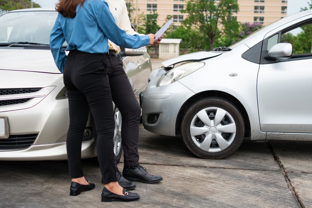Male and female drivers exchanging details after side collision car crash San Francisco